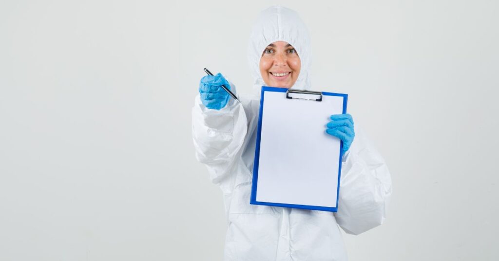 female doctor in protection suite with a checklist of what requires frequent safety and health inspections?